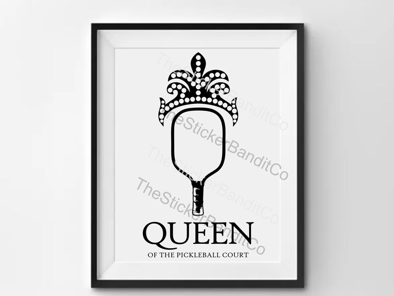 May include: Black and white illustration of a pickleball paddle with a crown on top. The text "QUEEN OF THE PICKLEBALL COURT" is below the paddle.