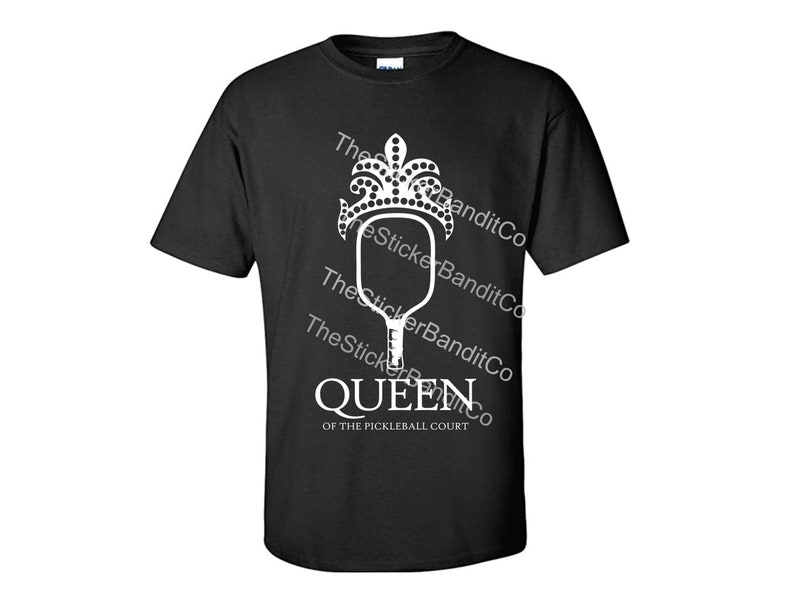 May include: Black t-shirt with a white graphic of a pickleball paddle with a crown on top. The text "Queen of the Pickleball Court" is below the graphic.