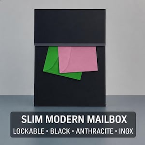 Op de afbeelding: Een zwarte, slanke, moderne brievenbus met een rechthoekig ontwerp. De brievenbus heeft een gleuf voor post en bevat een groene en een roze envelop. De tekst onderaan luidt "SLIM MODERN MAILBOX LOCKABLE • BLACK • ANTHRACITE • INOX."