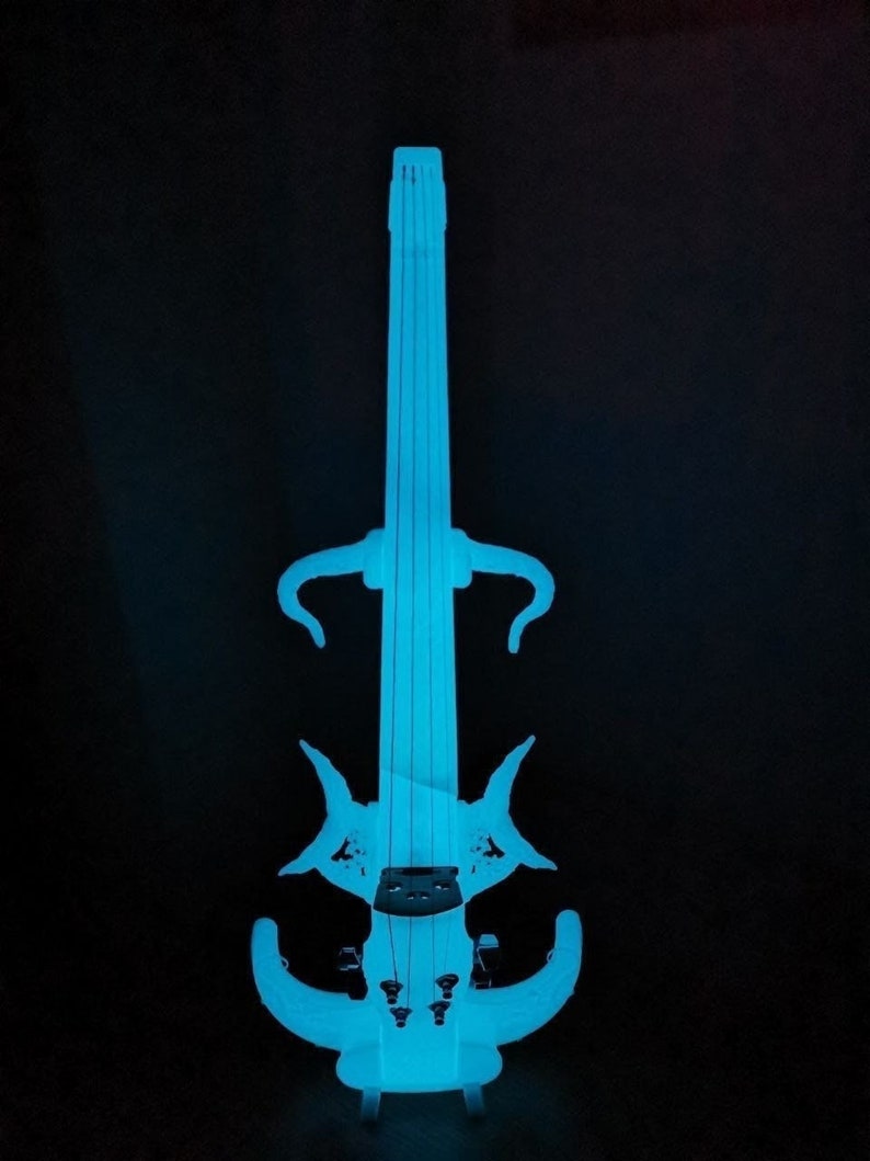 May include: A glowing blue electric violin with a unique design. The violin has a long neck and a body with a distinctive shape. The instrument is illuminated with a bright blue light.