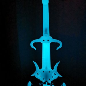 May include: A white electric violin with a blue glow. The violin has a unique design with horns and a pointed headstock.