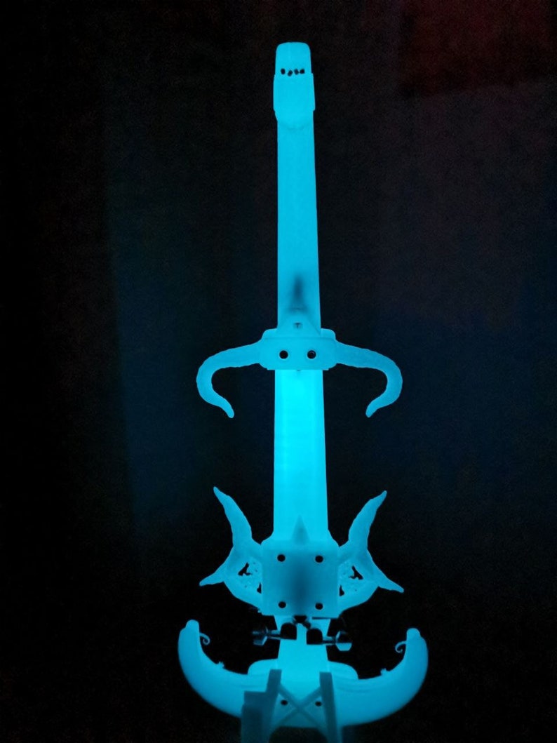 May include: A white electric violin with a blue glow. The violin has a unique design with horns and a pointed headstock.