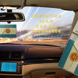 May include: A blue and white car air freshener featuring the Argentine flag. The text "Argentina Flag Car Air Freshener" is above the image. The text "Expo Designs Store" is below the image.