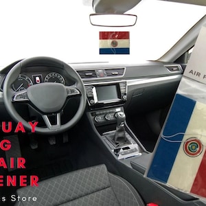 May include: A car air freshener featuring the flag of Paraguay. The air freshener is packaged in a clear plastic bag with a white header that reads "EXP Designs Air Fresheners".