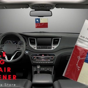 May include: Chilean flag car air freshener. The air freshener is packaged in a clear plastic bag with a white label that says "Expo Designs Air Fresheners".