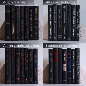 May include: A collection of hardcover books with black covers and various metallic lettering colors, including gold, silver, rose gold, and multicolor. The books are arranged in neat rows, showcasing titles and author names.