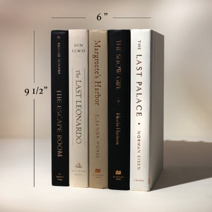 May include: A stack of five hardcover books, approximately 9.5 inches tall and 6 inches wide. The spines are black, cream, and white, with titles including "The Escape Room," "The Last Leonardo," "Margreete's Harbor," "The Show Girl," and "The Last Palace."
