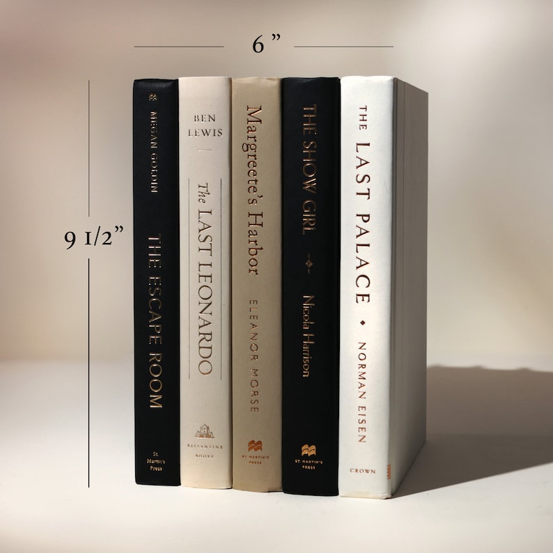 May include: A stack of five hardcover books, approximately 9.5 inches tall and 6 inches wide. The spines are black, cream, and white, with titles including "The Escape Room," "The Last Leonardo," "Margreete's Harbor," "The Show Girl," and "The Last Palace."