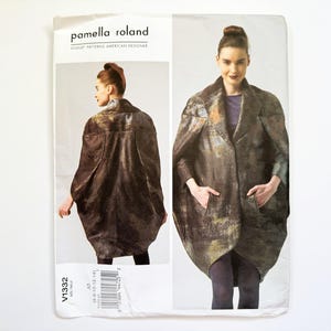 May include: A sewing pattern by Pamella Roland featuring a woman wearing a metallic-look coat. The pattern cover shows the coat from the front and back. The coat has large pockets and a unique shape.