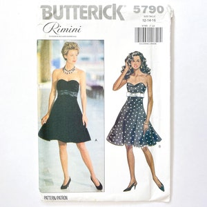 May include: A sewing pattern for a strapless dress with a fitted bodice and a full skirt. The pattern is for sizes 12-14-16 and is called "Rimini" by Butterick. The pattern shows two versions of the dress, one in black and one in black with white polka dots.