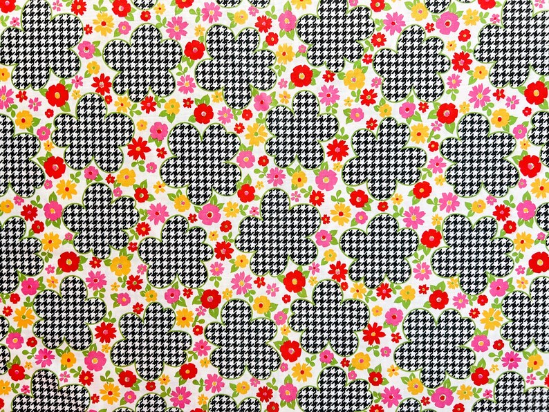 May include: A white fabric with a repeating pattern of black and white houndstooth flowers and pink, red, and yellow flowers.