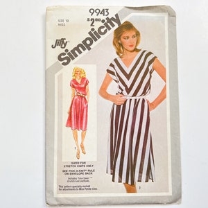 May include: Simplicity pattern 9943 for a dress sized for stretch knits only. The pattern includes two views: a pink dress with a V-neck and a black and white striped dress with a V-neck and a diagonal stripe pattern. The pattern is marked for adjustments to Miss Petites sizes.