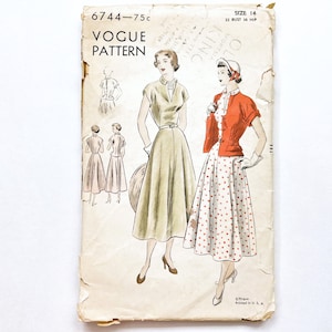 May include: Vintage Vogue sewing pattern, number 6744, for a dress with a skirt and a jacket. The pattern is for size 14, with a 32 inch bust and 35 inch hip. The pattern features two women wearing the dress and jacket, one in a green dress and the other in a white dress with red polka dots.