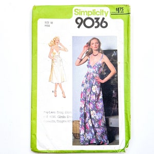 May include: Simplicity sewing pattern number 9036 for a dress. The pattern shows two models wearing different versions of the dress. One model is wearing a white dress with pockets and the other is wearing a floral print dress.