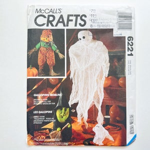 May include: A vintage McCall's Crafts pattern for making Halloween decorations. The pattern includes instructions for making a ghost, a scarecrow, and a goblin. The pattern number is 6221.