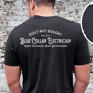 May include: Black t-shirt with a white circle graphic that says "Built Not Bought Est. 1924 Blue Collar Electrician High Voltage, High Standards".