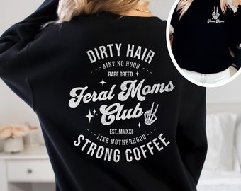 May include: Black sweatshirt with a white graphic print that says "Dirty Hair Ain't No Hood Rare Breed Feral Moms Club Est. MMXXI Like Motherhood Strong Coffee".