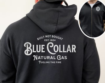 May include: Black zip-up hoodie with a white graphic on the back that says "Built Not Bought Est. 1924 Blue Collar Natural Gas Fueling The Fire".
