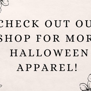May include: Black and white graphic with floral accents. Text reads: "CHECK OUT OUR SHOP FOR MORE HALLOWEEN APPAREL!"