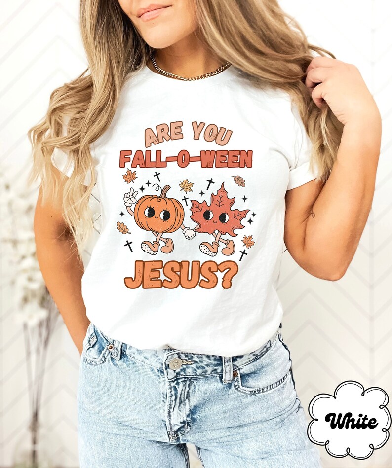 May include: White t-shirt with the text "Are you Fall-o-ween Jesus?"  A cartoon pumpkin and leaf are holding hands.