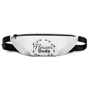May include: White fanny pack with a black adjustable strap and a black zipper. The fanny pack has a black and white graphic of a circle with the text "Flower Dude" inside.