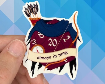 May include: A sticker featuring a burgundy D20 die with the number 20 in white. The die is adorned with a blue cape, a bow and arrow, and a banner that reads "always in range". A quiver of arrows is also present.