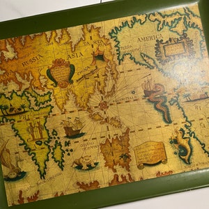 May include: A rectangular serving tray with a green border and a vintage world map design. The map features continents, oceans, and illustrations of ships and sea creatures in shades of brown, green, and gold.