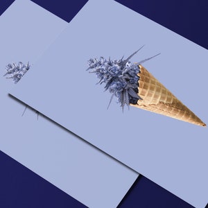 May include: A purple marijuana bud in a waffle cone on a light blue background.