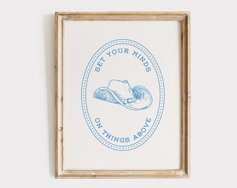 May include: A framed print with a blue and white illustration of a cowboy hat with the text "Set Your Minds On Things Above".