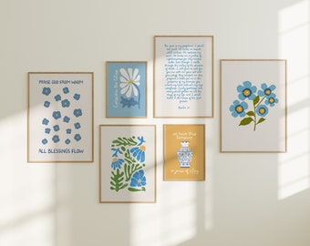 May include: A collection of framed art prints with floral and inspirational designs. The prints feature blue flowers, text, and a yellow background. The text includes phrases like "Praise God From Whom" and "All Blessings Flow."