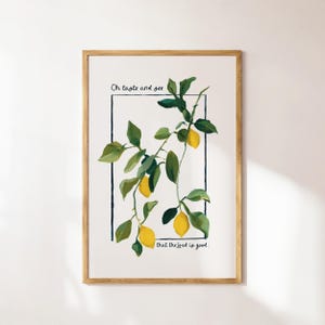 Puede incluir: Una impresión artística enmarcada con una ilustración en acuarela de una rama de limón con hojas verdes y limones amarillos. La obra de arte incluye el texto "Oh taste and see that the Lord is good" en negro, sobre un fondo blanco.