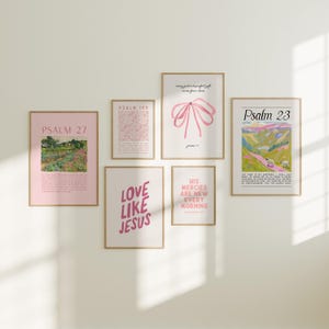 May include: A set of six framed prints with pink and white text and images. The prints feature bible verses, including Psalm 23, Psalm 27, and Psalm 139. The prints are arranged in a grid pattern on a white wall.