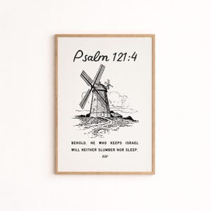 May include: A framed print featuring a black and white illustration of a windmill. The text "Psalm 121:4" is at the top, with the quote "BEHOLD, HE WHO KEEPS ISRAEL WILL NEITHER SLUMBER NOR SLEEP" below the windmill. The print is in a light brown frame.