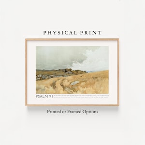 May include: A framed print featuring a landscape painting with a muted color palette. The artwork depicts a field of golden grass under a cloudy sky. The text "PSALM 91" and other text are visible at the bottom of the print. The frame is a light wood color.