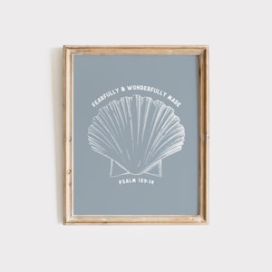 May include: A framed print with a blue background and a white illustration of a seashell. The text "Fearfully & Wonderfully Made" is written in a circle around the seashell. The text "Psalm 139:14" is written below the seashell.