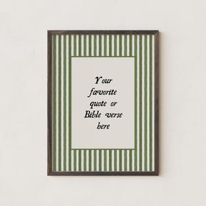 May include: A rectangular wall art print in a dark wood frame featuring a cream-colored center panel with the black text 'Your favorite quote or Bible verse here' surrounded by a border of vertical olive green and white stripes.