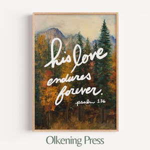 May include: A framed art print featuring a landscape painting of a forest and mountains. White script reads "his love endures forever. psalm 136." The artwork is in a wooden frame. The text "Olkening Press" is at the bottom.