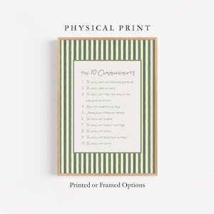 May include: A framed print featuring the text "The 10 Commandments" in a handwritten style. The print has a white background with the text in black, framed by a green and white striped border and a wooden frame. The words "Physical Print" and "Printed or Framed Options" are also visible.