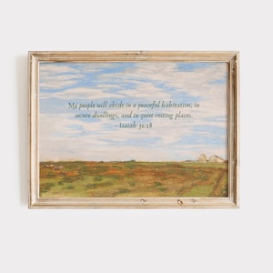 May include: Framed landscape art print featuring a serene countryside scene with a blue sky and text from Isaiah 32:18. The artwork has a vintage aesthetic with a wooden frame, depicting a field and distant buildings.