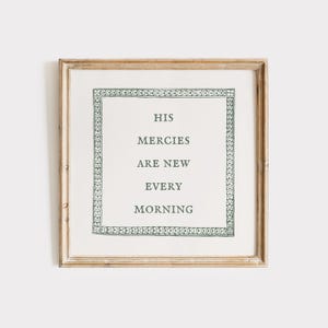 May include: A framed print with a white background and a green border. The print features the text "His mercies are new every morning".