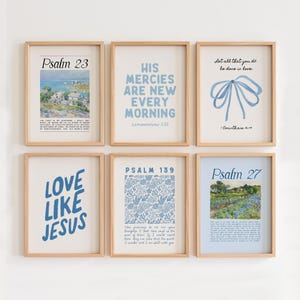 May include: Six framed art prints with inspirational quotes and scripture verses. The prints feature various designs, including floral patterns, landscape paintings, and text in blue and white. The frames are a light wood color.