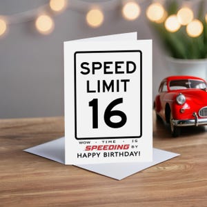 Celebrate their 16th birthday with a charming Speed Limit Birthday Card, beautifully displayed alongside a classic red model car. This delightful pairing adds a nostalgic touch to their special birthday.