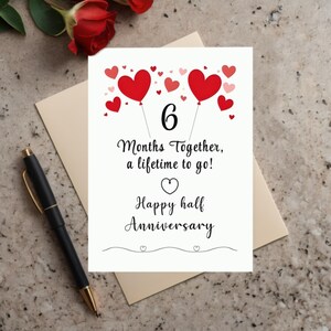 Celebrate  your 6-month anniversary with a card featuring vibrant red and pink hearts at the top and the heartfelt message, '6 months together, a lifetime to go!' This simple and elegant design perfectly captures the joy of your milestone.