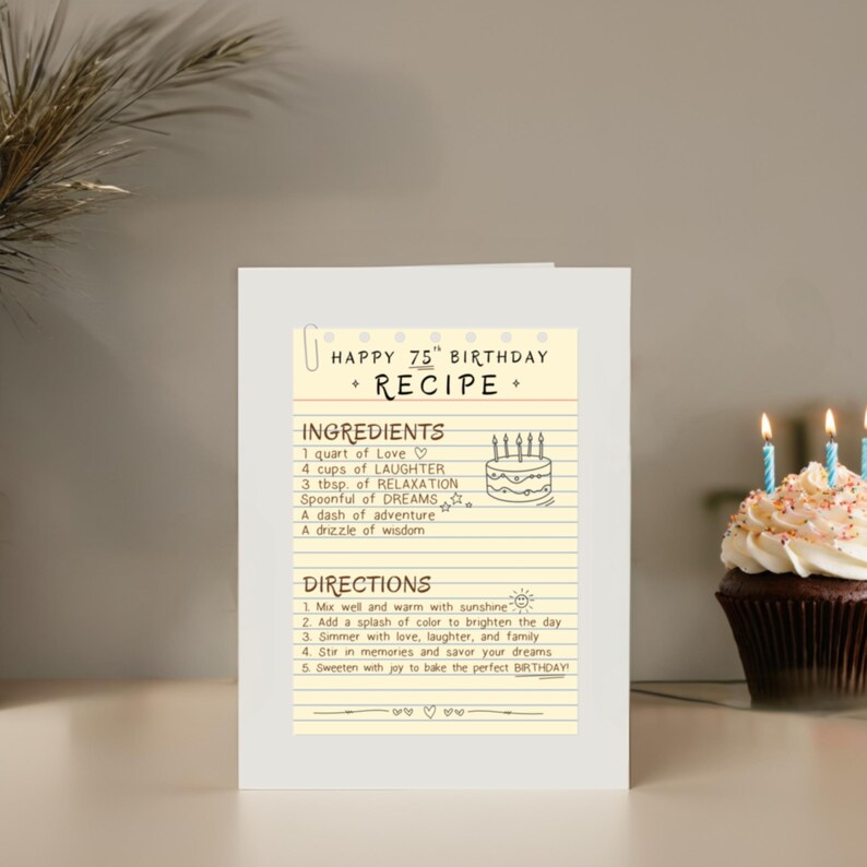 Celebrate their 75th with a one of a kind recipe birthday card, displayed near one cupcake with birthday candles. The card is filled with ingredients like relaxation, laughter, and dreams which offers a great way of wishing a happy 75th birthday