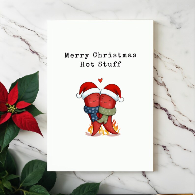 This card features two adorable hot peppers hugging in love, complete with a flame underneath and Santa hats for a holiday touch. The message Merry Christmas Hot Stuff adds a spicy, romantic vibe, making it perfect for your partner this Christmas.