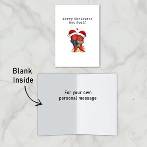 This festive card features two hot peppers hugging in love, with a flame below and Santa hats for a holiday touch. The message, Merry Christmas Hot Stuff, adds spice to your holidays. The card is blank inside to write your own personal message