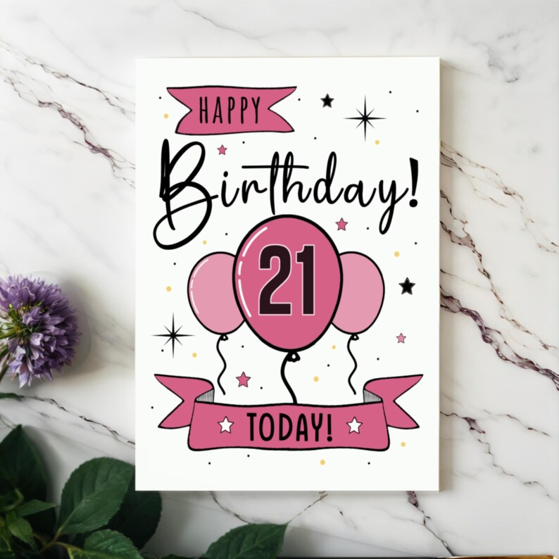Celebrate their 21st birthday with our elegant Happy 21st Birthday card, beautifully presented next to purple flowers on a white granite countertop.
