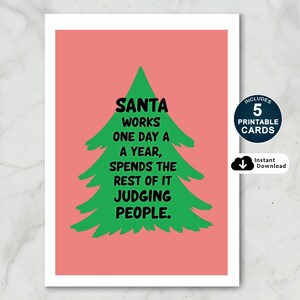 Brighten someone’s holiday with a cheerful Christmas card featuring a playful take on the holiday season! The card has a salmon-colored background that really pops against the large green Christmas tree silhouette in the center. The tree has a rough, hand-painted appearance with jagged edges, giving it a charming and homemade feel. In bold, black, handwritten-style font, the text "SANTA WORKS ONE DAY A YEAR, SPENDS THE REST OF IT JUDGING PEOPLE"