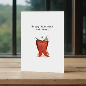 Add some spice to their birthday with this pun-filled card featuring two red chili peppers in love! Perfect for the hot stuff in your life, this fun design is a great way to show your love to a partner who brings the heat!