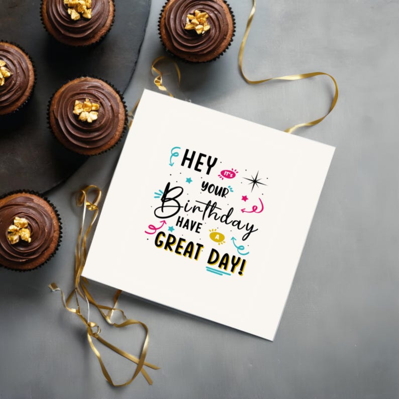 Displayed on a table next to delicious chocolate cupcakes, the 'Hey, it's Your Birthday!' Card adds a sweet and cheerful touch to the party.
